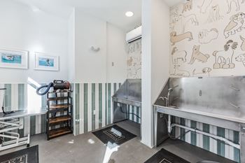 A large industrial kitchen with stainless steel appliances and wallpaper